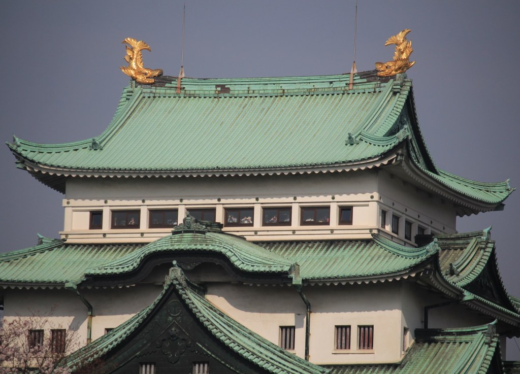 The golden shachihoko (kinshachi) at both ends of the top ridge of Nagoya Castle's green-roofed keep